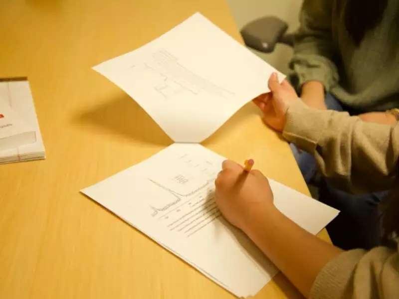 Writing Fellow's hands working with students